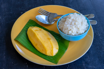 Thai style dessert, mango with sticky rice on plate. Yellow mango and sticky rice is popular traditional dessert of Thailand