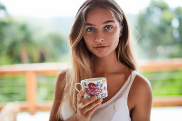 Beautiful girl with morning tea, portrait