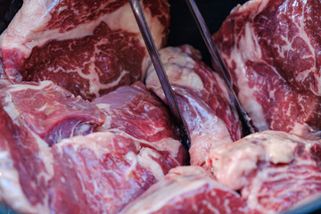 Raw steaks with seasonings. BBQ meat.