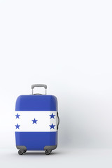 Travel suitcase with the flag of Honduras. Holiday destination. 3D Render