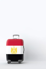 Travel suitcase with the flag of Egypt. Holiday destination. 3D Render