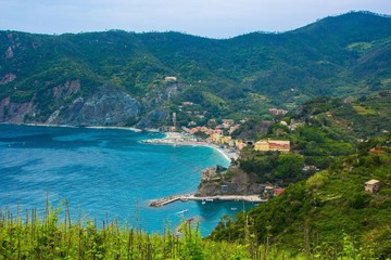 Fototapeta na wymiar Beautiful small town of Monterosso in the Cinque Terre national Park. Italian colorful landscapes. View from the mountain Hiking trekking route.