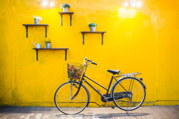 Fototapeta na wymiar Vintage bicycle on vintage yellow wall