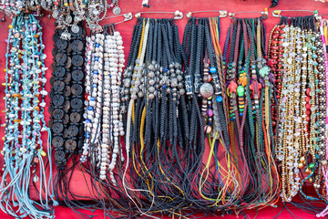 Colorful bracelets for sale on street at night market, Thailand. Souvenirs for tourists at market , close up