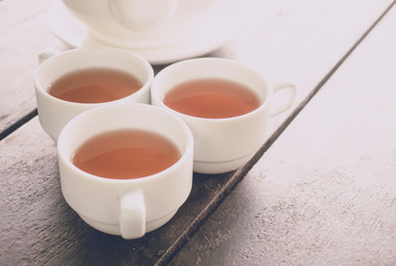 Obraz na płótnie Canvas Hot tea serving on wood table background with soft light morning
