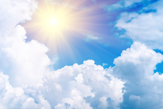 Blue sky with white clouds and sun. Sky background