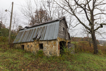 Obraz premium Angled view of vintage barn on abandoned property