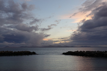 Fototapeta na wymiar Groyne with stormy dark clouds in the background.