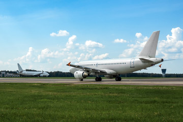 White modern commercial airplane on the runway of airport
