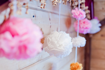 Festive decoration of paper pink and white pompons