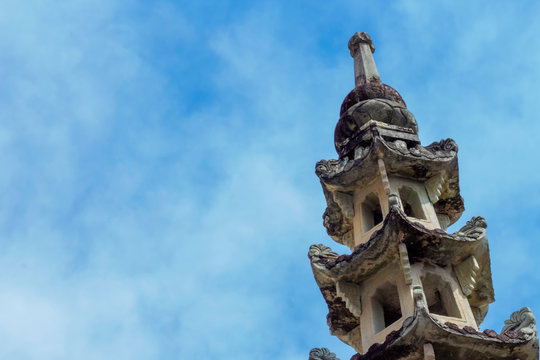 Old chinese pagoda is wat kalayanamit woramahawiharn with a background is blue sky with cloudy