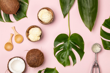 Creative flat lay with coconut ice cream and tropical plants