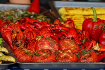 roasted and steamed vegetables from tomatoes and red bell peppers on a metal plate