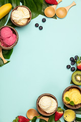 Tropical fruits and plants with variety of ice cream in coconut shells