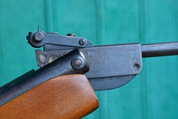 piece of air rifle from ferrous metal and brown wood