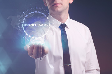 The concept of business, technology, the Internet and the network. A young entrepreneur working on a virtual screen of the future and sees the inscription: Recommendation