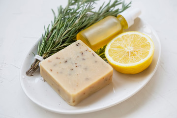 Organic natural spa and skincare ingredients with natural soap, lemon, oil bottle and rosemary herb, natural spa ingredients, natural beauty and skincare concept