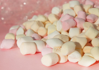 Marshmallows on pink background with copyspace. Flat lay or top view with boke on background.
