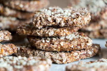 Vegan cookies from wheat and raisins stacked on plate. Front view.