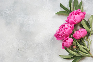 Bouquet of pink peony flowers on vintage table. Copy space.