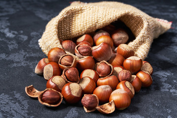 Hazelnut  are poured out of the bag on a black table,Close-up