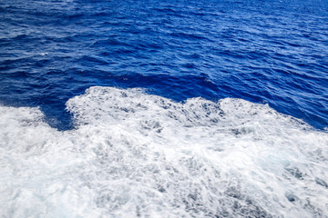 Naklejka na ściany i meble Deep blue sea with foam on the surface
