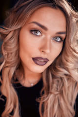 Naklejka premium Close up view of beautiful woman lips with purple matt lipstick. Open mouth with white teeth. Cosmetology, drugstore or fashion makeup concept. Beauty studio shot. Passionate kiss