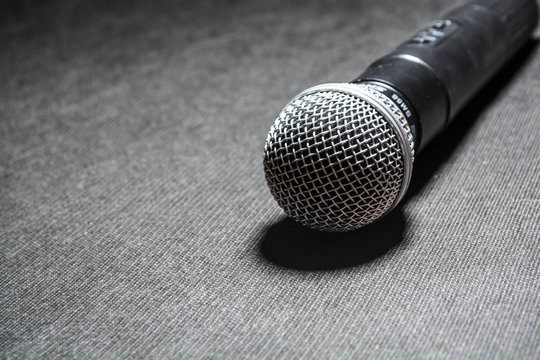 Black background. The microphone for singing. Karaoke. Modern technologies. Music. Gadgets.