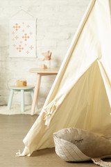 Tent, crib and kids furniture in the nursery room, nicely decorated kids room