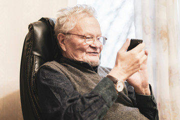 old senior man in glasses using mobile phone b