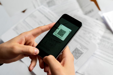 persons hand hold spartphone scanning qr code b