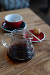 Bruch chemex coffeemaker cup of coffee. Black espresso, wooden texture background table