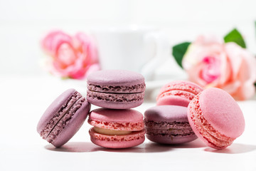 macaroon cookies and flowers on white background