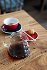 Bruch chemex coffeemaker cup of coffee. Black espresso, wooden texture background table