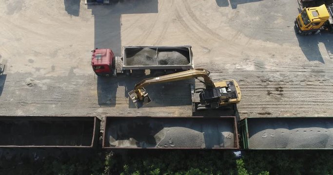 Aerial view: Unloading gravel on the asphalt factory. 4k