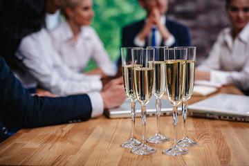 Champagne for businessmen at the meeting. Selective focus