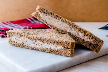Triangle Light Sandwich with Tuna Fish Paste on Marble Board.