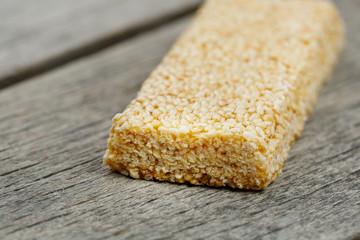 Sesame seed casinos on old vintage background with burlap cloth. Country style. Delicious sweets from seeds of sunflower, sesame and peanuts, covered with shiny glaze