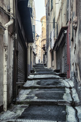 Fototapeta premium Impression of the narrow street Via Saccheri in the center of the Italian town San Remo