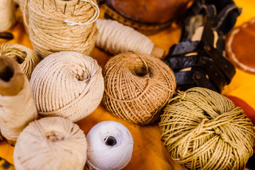 Fototapeta na wymiar Balls of yarn, wool and rope of earth colors.