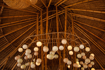 traditional bamboo roof and white round lamps in Bali