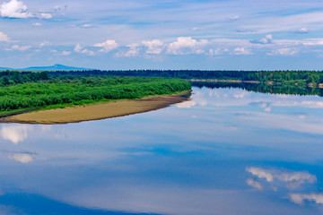Fototapeta premium river with reflections of clouds on a summer day