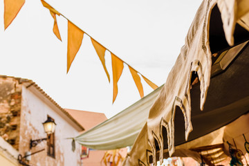 Traditional pennants placed on a street of a mediterranean city.