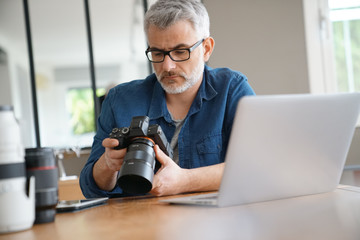 Photographer in office checking shots