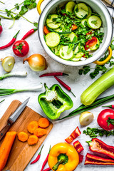 cooking vegetables on the stone background top view