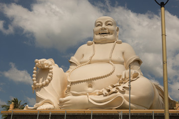 Big laughing sitting outdoor Buddha in Vinh Trang Pagoda in South Vietnam