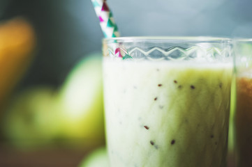 Green smoothies on a dark background. Apple and kiwi smoothies. Healthy eating concept close up and copy space.