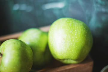 Natural textured green apples close up and copy space. Apples, healthy food concept, toned photo