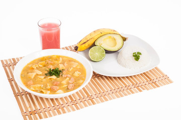 tasty typical Colombian food; Mondongo of soup with avocado, banana and white rice