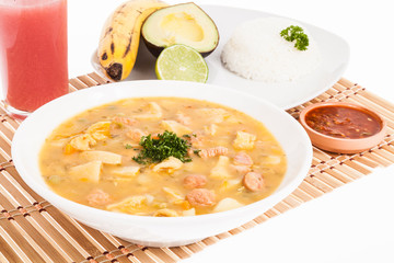 tasty typical Colombian food; Mondongo of soup with avocado, banana and white rice